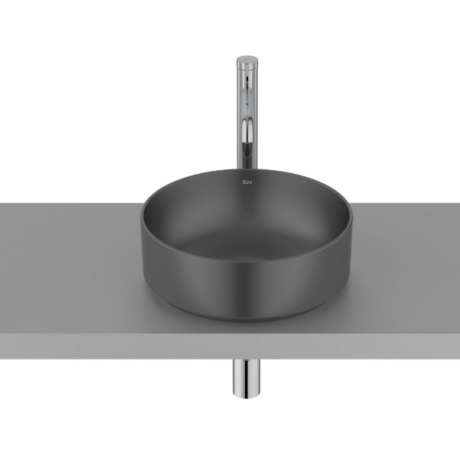 Round gray basin sink with a tall chrome faucet on a gray countertop.