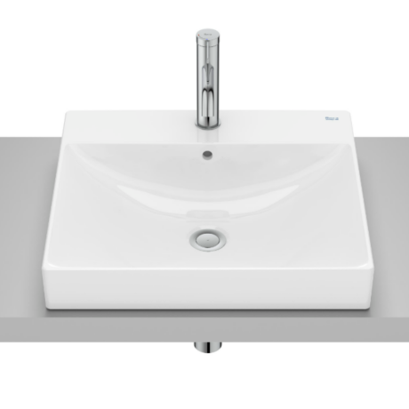 Rectangular white ceramic bathroom sink with a tall chrome faucet on a gray countertop, viewed from above.