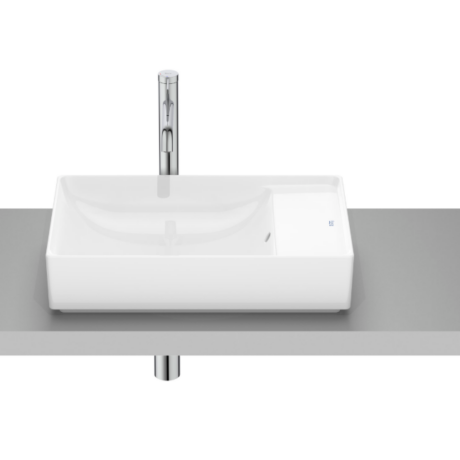 White rectangular bathroom sink with a tall chrome faucet on a gray counter, modern design
