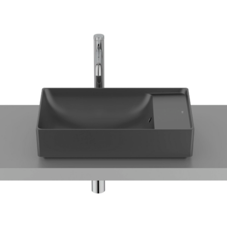 Rectangular dark gray bathroom sink on a gray countertop with a tall chrome faucet and exposed plumbing beneath.
