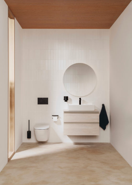 Екранна снимка 2026-07-26 173543 - Мебели за баня и душкабини Minimalist bathroom with a wall-mounted toilet, circular mirror, and floating wooden vanity with sink; black fixtures and a towel hanging on the right. White tiled walls and beige floor.