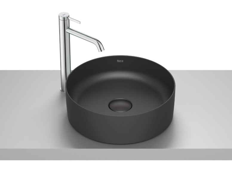 Екранна снимка 2026-07-26 180249 - Мебели за баня и душкабини Round matte black vessel sink with a tall chrome faucet on a light gray countertop.