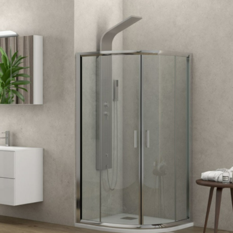 Modern bathroom with a glass corner shower enclosure beside a white vanity and potted plant.