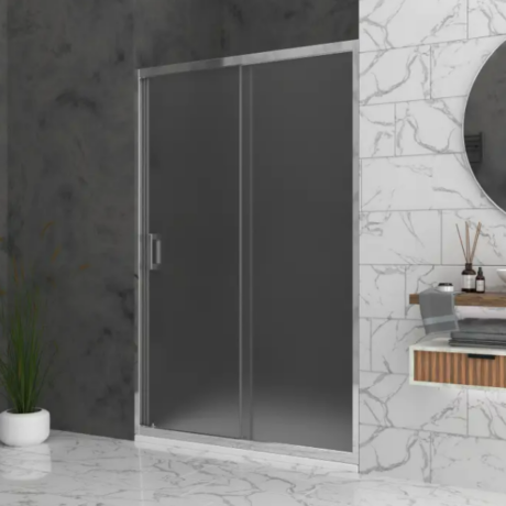 Frameless glass shower door with a metal frame in a marble-tiled bathroom, beside a plant in a white pot and a floating vanity mirror area.