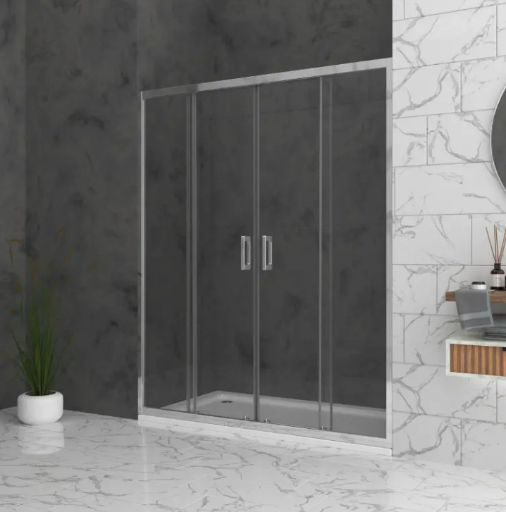 Glass shower enclosure with sliding doors and chrome handles in a marble-tiled bathroom with a potted plant nearby below a dark wall lighted backdrop.