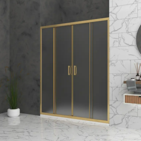 Gold-framed glass shower door with dark panels in a marble-floored bathroom.