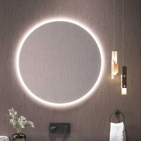 Modern bathroom with a large backlit circular mirror, vertical pendant lights, and a towel ring with a white towel.