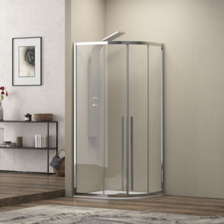 Curved glass shower enclosure with chrome frame in a modern bathroom setting.