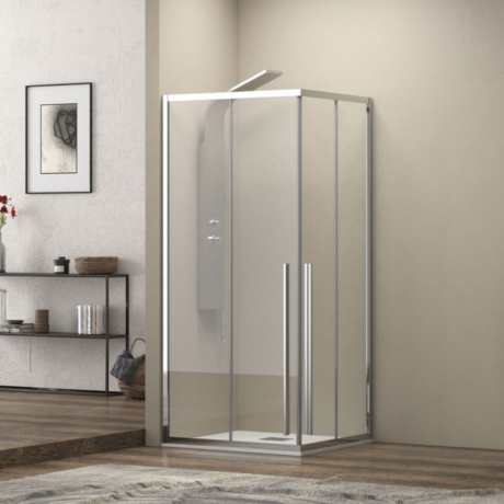 Modern glass shower enclosure with chrome frame in a bathroom corner, featuring a sliding door and overhead light panel on the wall behind.