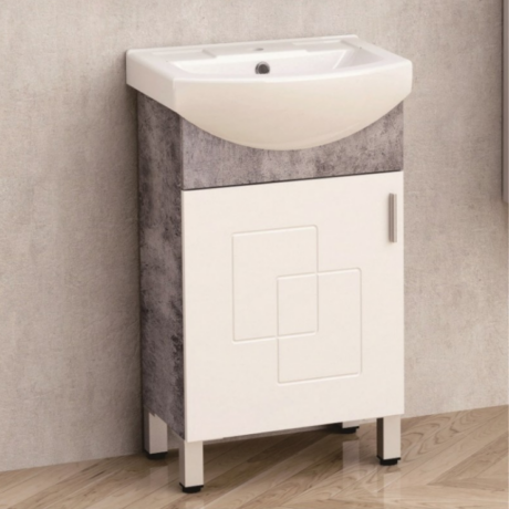 White bathroom vanity with integrated sink and storage cabinet against a tiled wall.