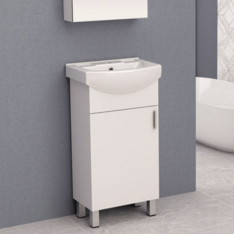White bathroom vanity with sink and storage cabinet against a gray wall, with a wall mirror above.