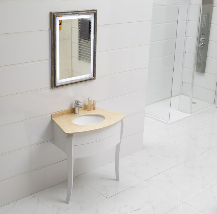 Modern bathroom with white tiled walls, a marble floor, and a curved vanity featuring an oval sink and beige countertop.