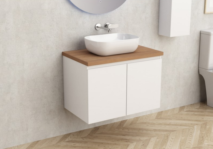 White wall-mounted bathroom vanity with a wooden countertop and an oval vessel sink on top.