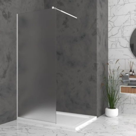 Minimalist walk-in shower with a frosted glass panel and chrome rail in a marble-tiled bathroom.