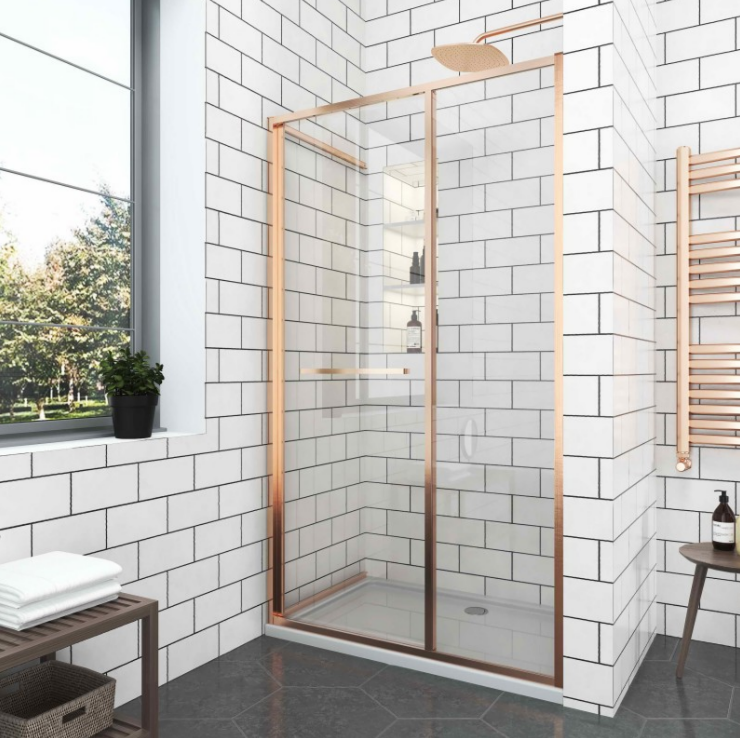 изображение_2026-08-04_151350495 - Мебели за баня и душкабини Modern bathroom with a rose-gold framed glass shower enclosure, white subway-tile walls, and a window with a plant on the sill.