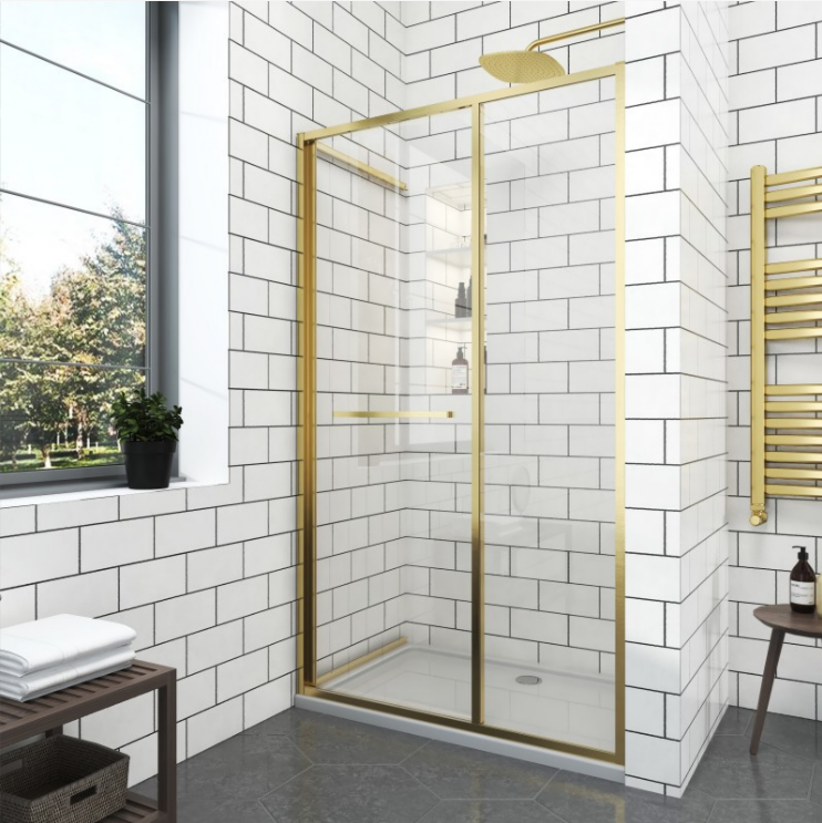 изображение_2026-08-04_152810974 - Мебели за баня и душкабини Gold-framed glass shower enclosure in a modern white-tiled bathroom with a rainfall showerhead and a small shelf inside.